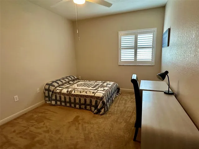 a bedroom with a bed and a chair in it