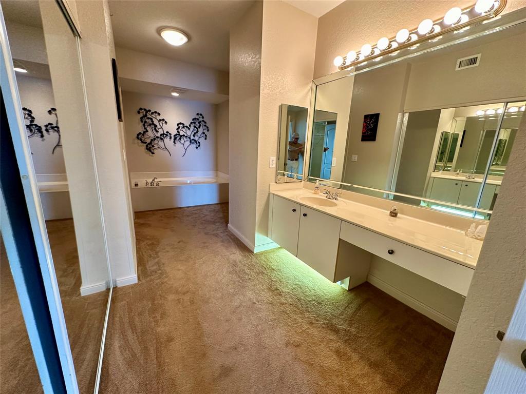 7727 Southampton Terrace, Unit 303 Tamarac, FL 33321 - Photo 15 of 23 a bathroom with a sink mirror and a bathtub