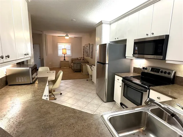 a kitchen with a refrigerator a stove top oven a sink and dishwasher