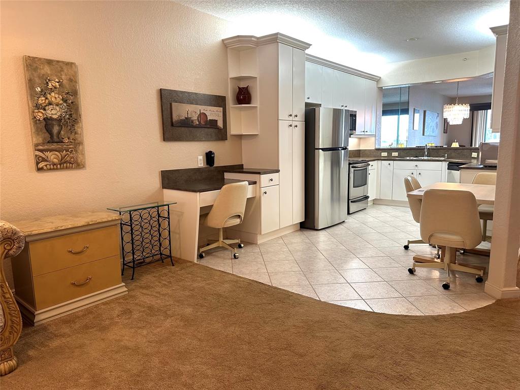 7727 Southampton Terrace, Unit 303 Tamarac, FL 33321 - Photo 19 of 23 a kitchen with a refrigerator and a stove top oven