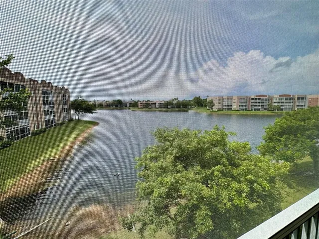 a view of a lake with houses in the back