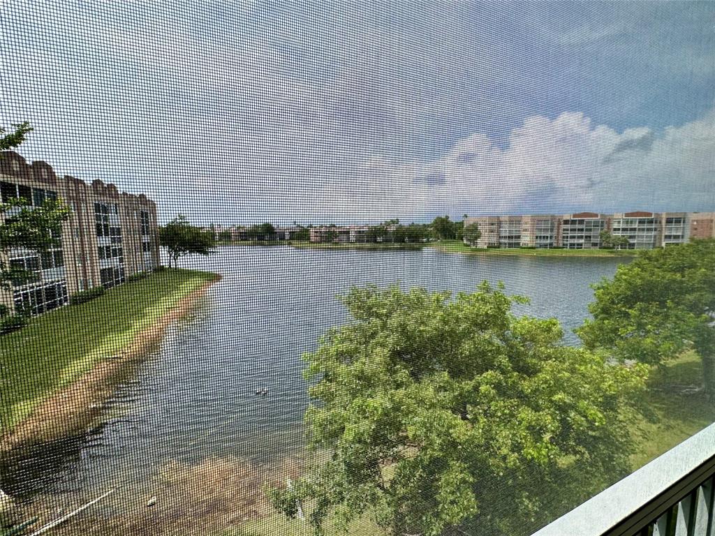 7727 Southampton Terrace, Unit 303 Tamarac, FL 33321 - Photo 2 of 23 a view of a lake with houses in the back