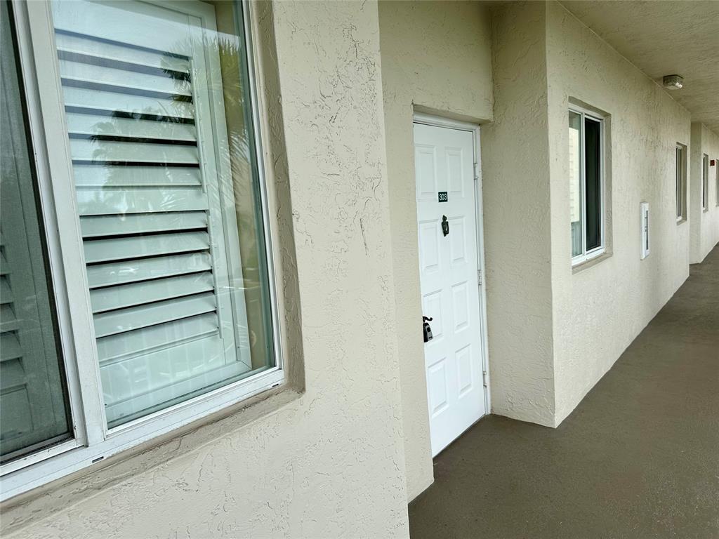 7727 Southampton Terrace, Unit 303 Tamarac, FL 33321 - Photo 21 of 23 a view of a hallway with a white walls