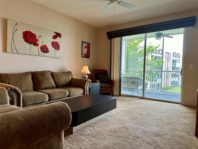 a living room with furniture cabinets and a large window