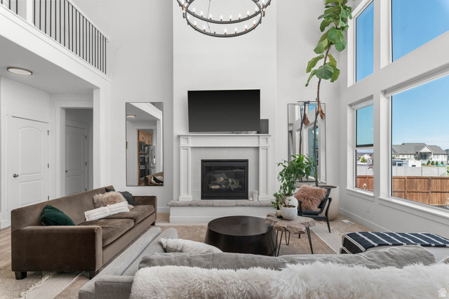 500 North 516th Street West, Unit 19 Mapleton, UT 84664 - Photo 3 of 41 Spacious living area featuring a two-story ceiling, multiple large windows, and an upper-level railing