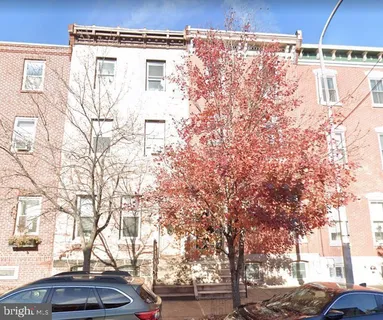a view of a building with snow on the road