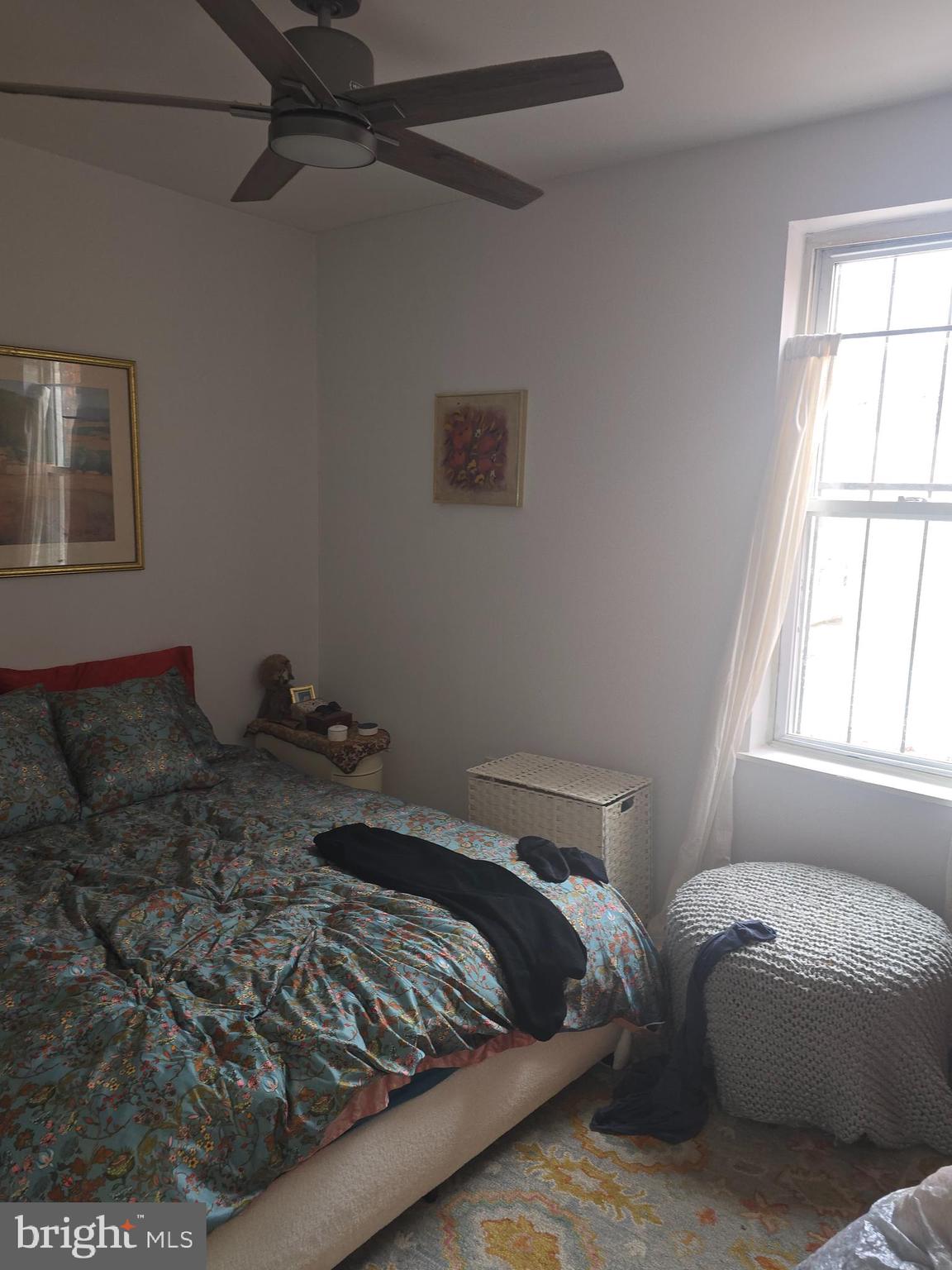 1523 Christian Street, Unit 2R Philadelphia, PA 19146 - Photo 13 of 18 a bed sitting in a bedroom next to a window