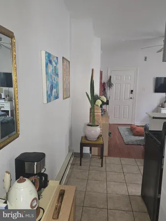a bedroom with a bed and painting on the wall