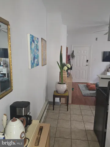 a bedroom with a bed and painting on the wall