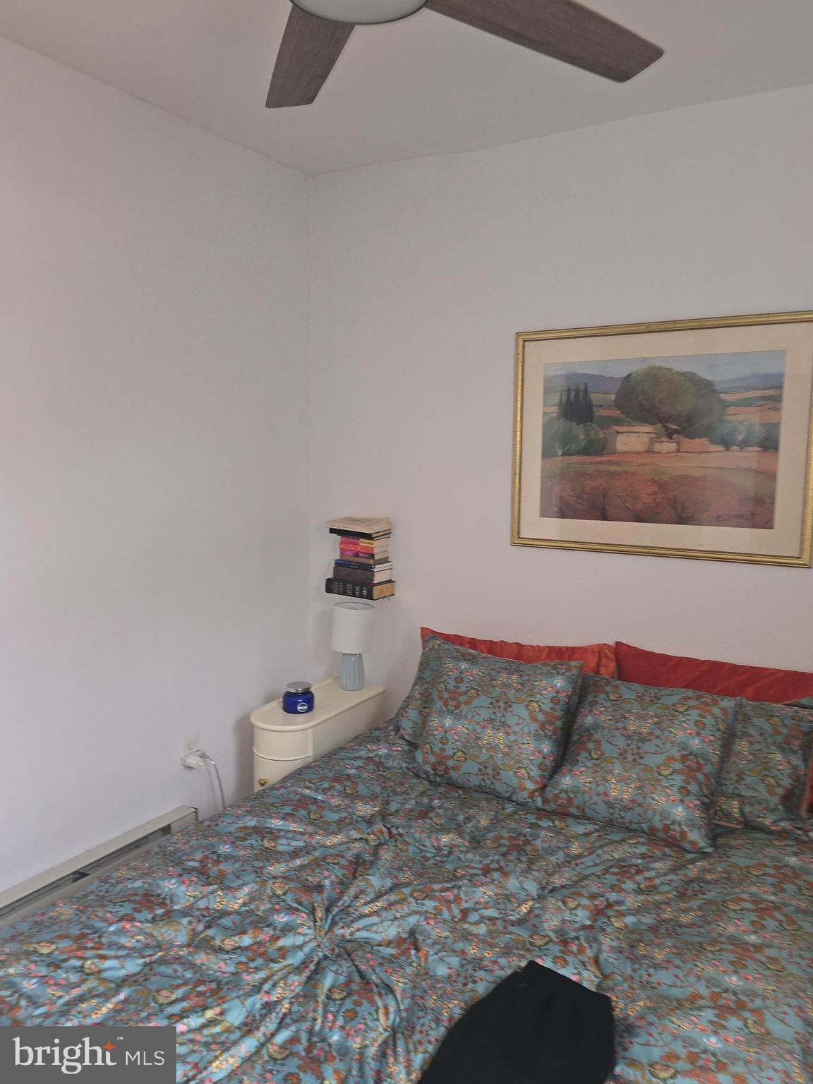 1523 Christian Street, Unit 2R Philadelphia, PA 19146 - Photo 15 of 18 a bedroom with a bed and painting on the wall