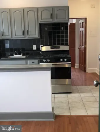 a kitchen with granite countertop a stove and a refrigerator