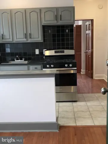 a kitchen with granite countertop a stove and a refrigerator