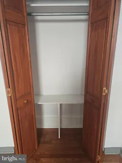 a room with a wooden floor and a window