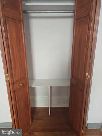 a room with a wooden floor and a window