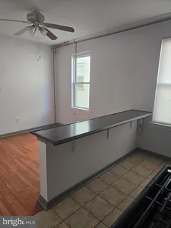 a kitchen with granite countertop a refrigerator stove and sink
