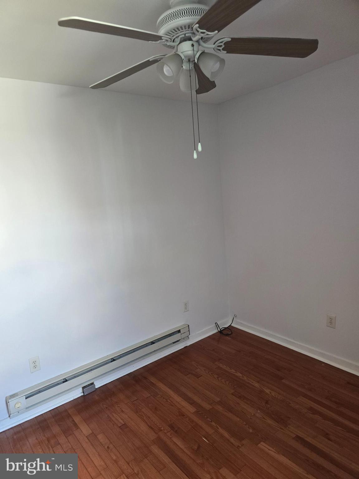 1523 Christian Street, Unit 2R Philadelphia, PA 19146 - Photo 9 of 18 a view of a room with wooden floor and white walls