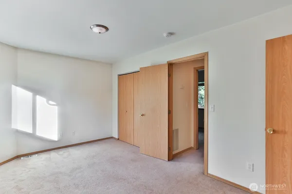 a view of an empty room and a window