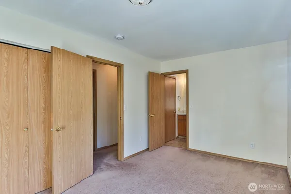 an empty room with closet area