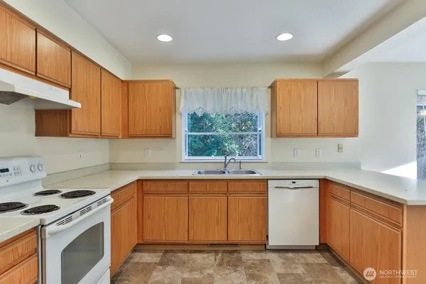 a kitchen with a sink stove and cabinets