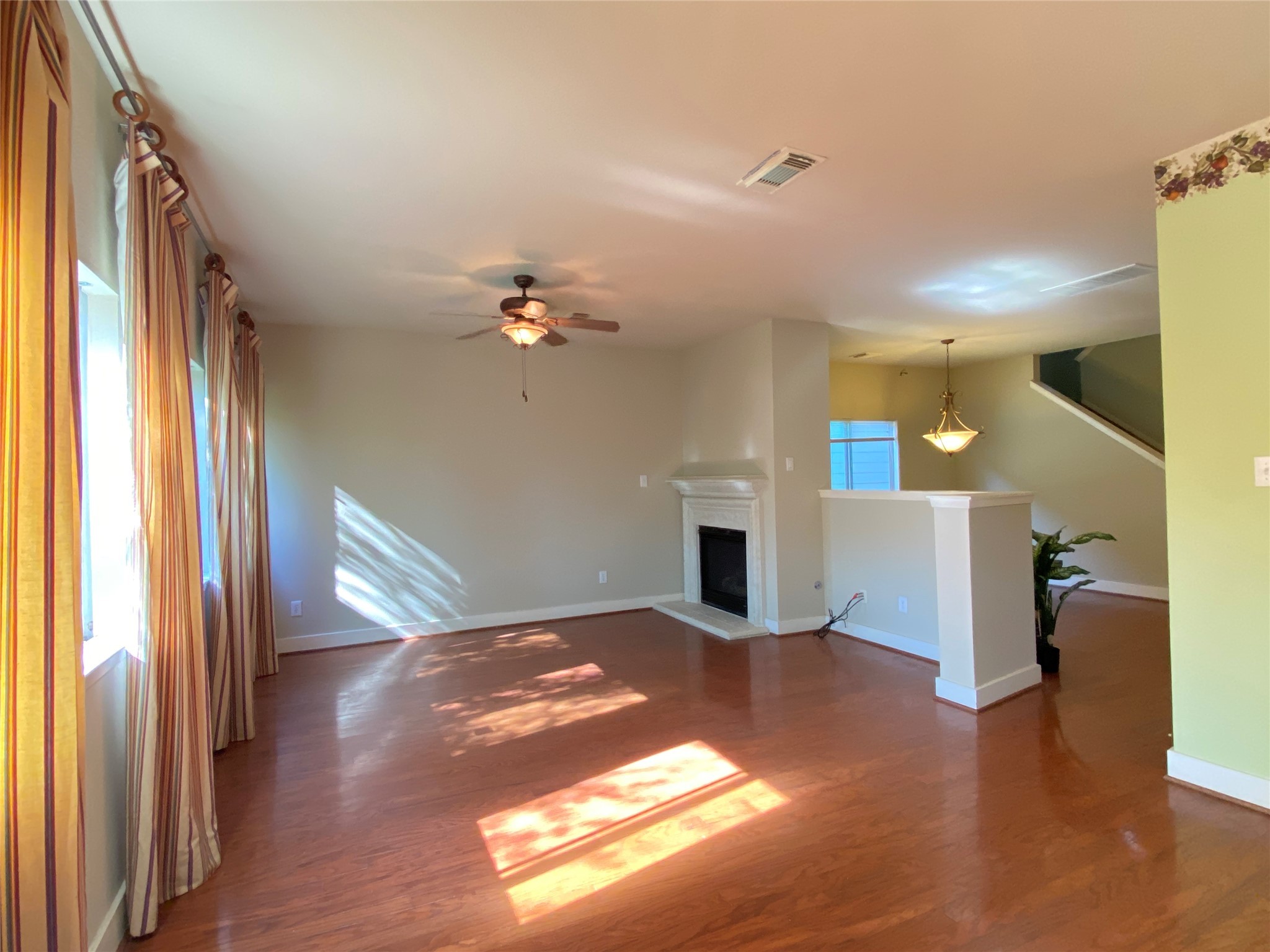 5843 Sonoma Ridge Missouri City, TX 77459 - Photo 6 of 20 a view of an empty room with a window and wooden floor
