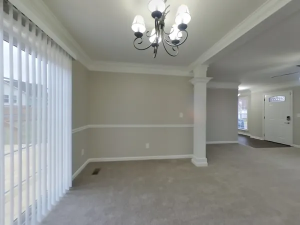 a view of a chandelier in big room and chandelier fan