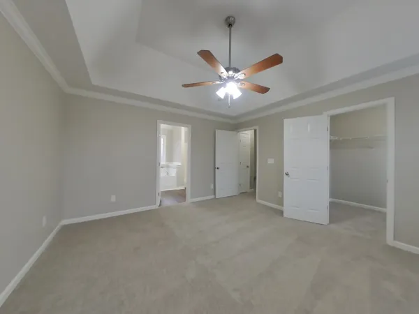 an empty room with a ceiling fan and a window