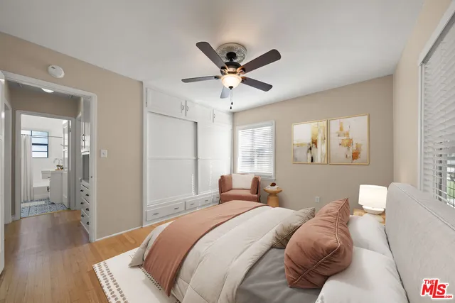 a bedroom with bed and a chandelier