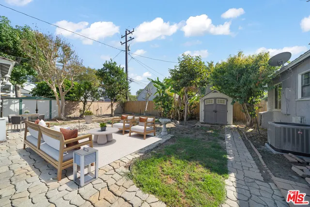 a view of a backyard with sitting area
