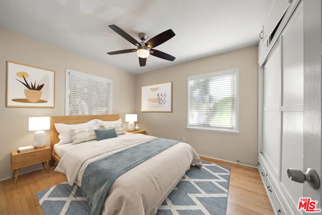 a bedroom with a large bed and a window