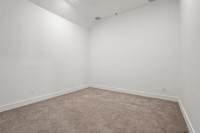 a view of a hallway with wooden floor and a door