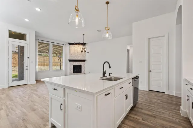 a large kitchen with stainless steel appliances granite countertop a refrigerator and a sink