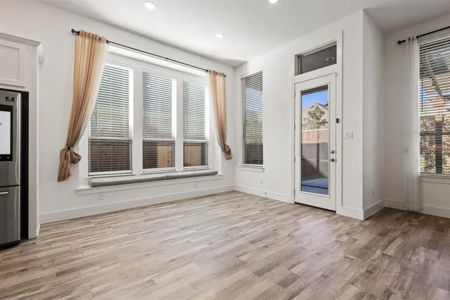 a view of empty room with wooden floor and fireplace
