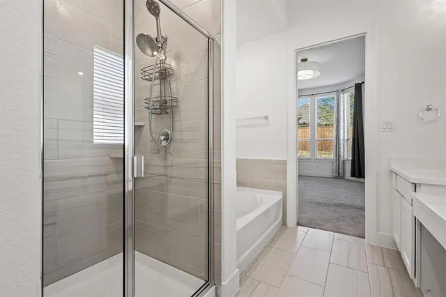 a view of an empty room with wooden floor and fence