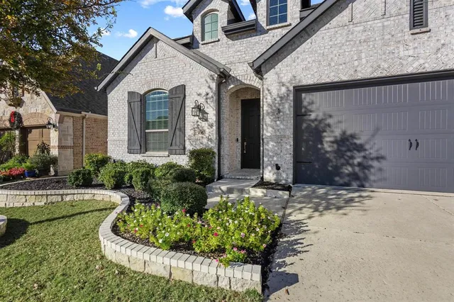a front view of a house with garden