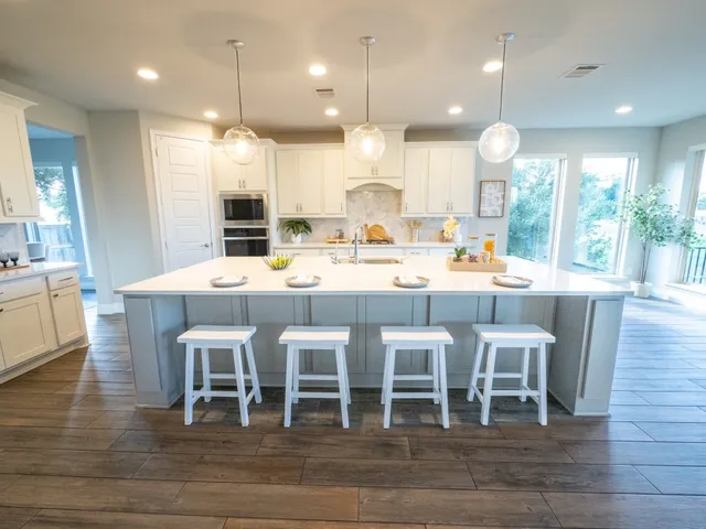 a large kitchen with a table and chairs