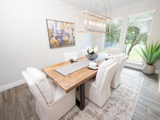 a view of a dining room with furniture wooden floor and a chandelier
