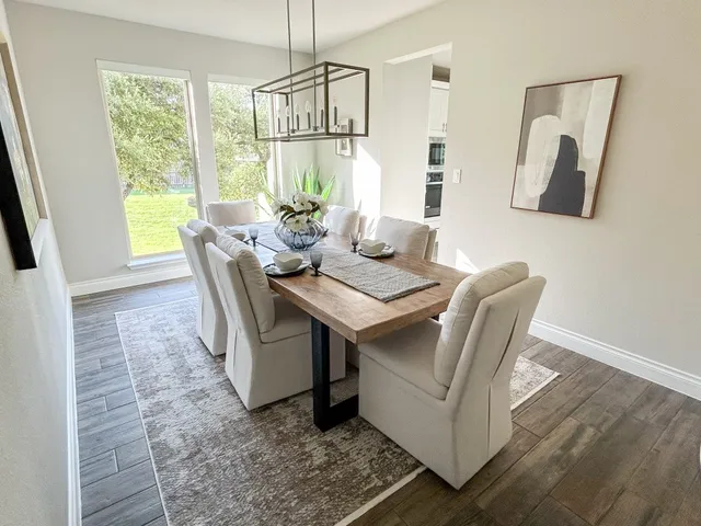 a dining room with furniture and window