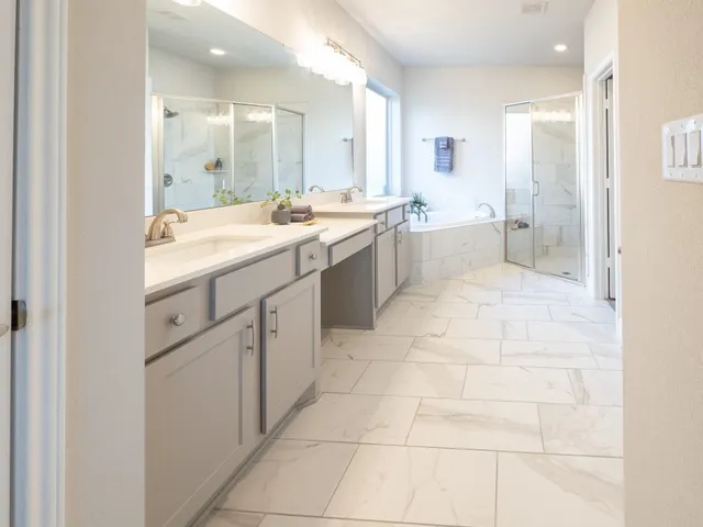 a large bathroom with a sink a mirror and a bathtub