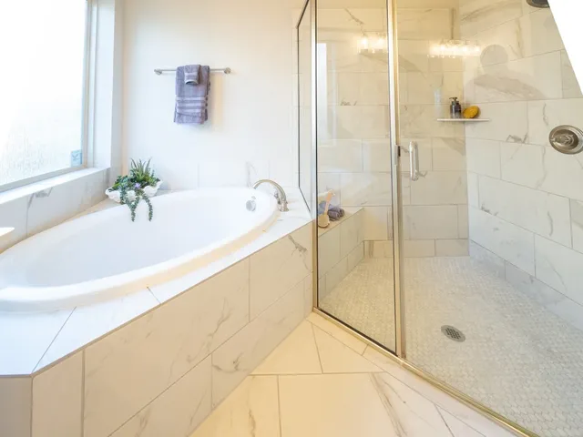 a bathroom with a bathtub and a shower