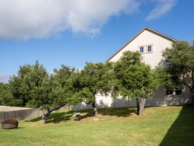 a view of a swimming pool with a garden and trees
