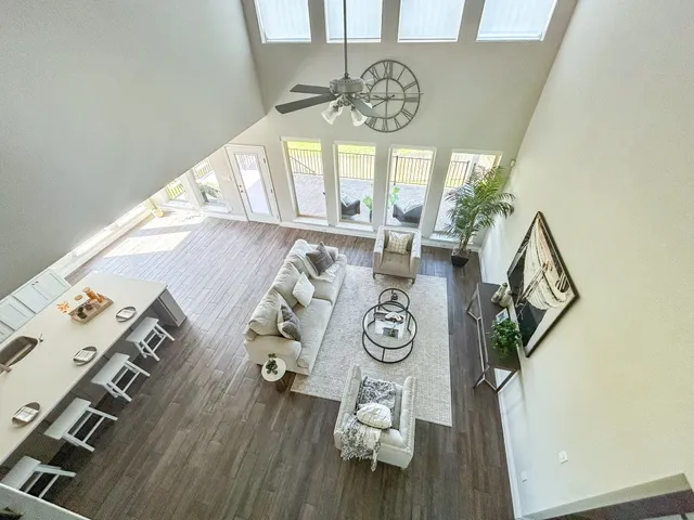 a view of a dining room with furniture a chandelier and wooden floor