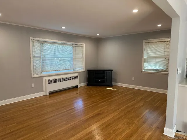a view of an entryway with wooden floor