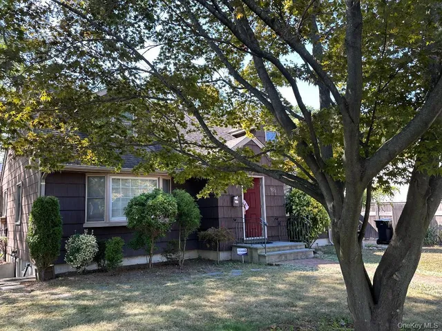 a view of a house with a tree in front of a house