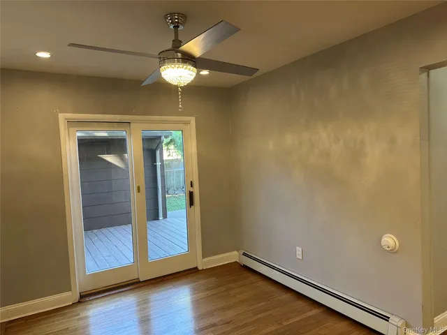 a kitchen with a checkered floor and white cabinets