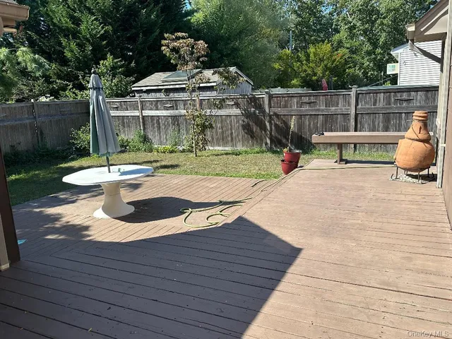 a view of a chair and table on the wooden deck