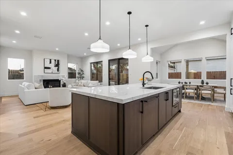 a kitchen with stainless steel appliances granite countertop a stove and a sink