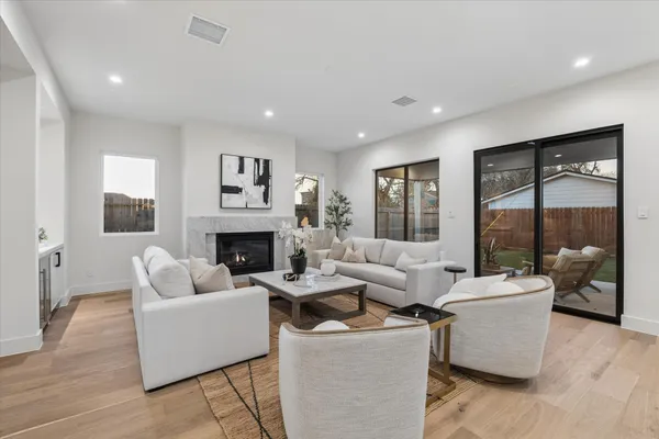 a kitchen with a dining table chairs sink and wooden floor
