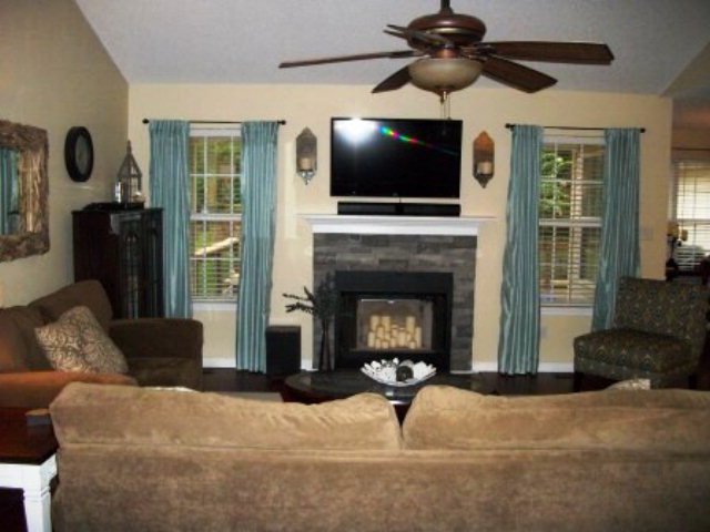 103 Craig Road Forsyth, GA 31029 - Photo 2 of 13 a living room with furniture a flat screen tv and a fireplace
