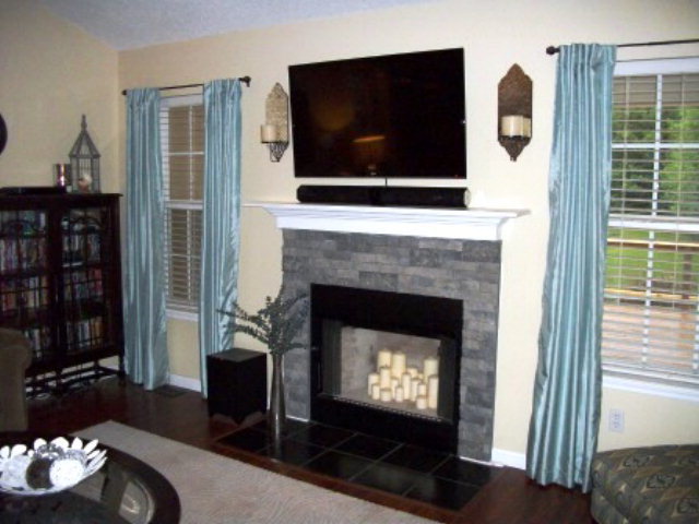 103 Craig Road Forsyth, GA 31029 - Photo 3 of 13 a living room with furniture a flat screen tv and a fireplace