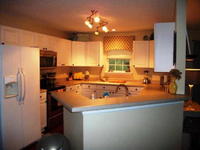 103 Craig Road Forsyth, GA 31029 - Photo 5 of 13 a room with stainless steel appliances a table chairs refrigerator and a sink
